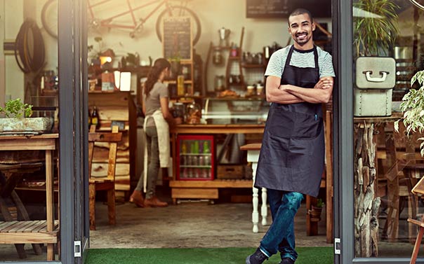 Business owner standing in their store front